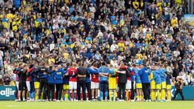 Soccer Football - International Friendly - Denmark v Ukraine - Odense, Denmark - June 7, 2026 Ukraine and Denmark players and staff huddle after the match was abandoned due to Denmark's Christian Eriksen collapsing on the pitch during the match. Bo A