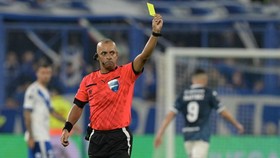 Brazilian referee Wilton Pereira Sampaio shows a yellow card during the Copa Libertadores quarterfinal first leg all-Argentine football match between Velez Sarsfield and Racing at the Jose Amalfitani Stadium in Buenos Aires on September 16, 2025. (Ph