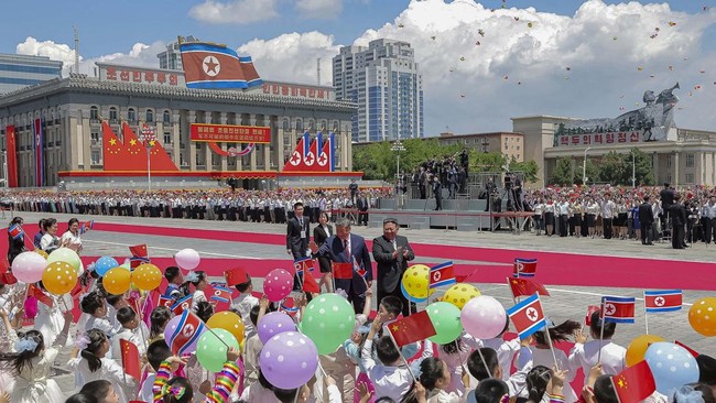 Chinese President Xi Jinping walks with North Korean leader Kim Jong Un during a welcoming ceremony, amid his state visit, at Kim Il Sung Square in Pyongyang, North Korea, June 8, 2026, in this picture released by North Korea's official Korean Centra