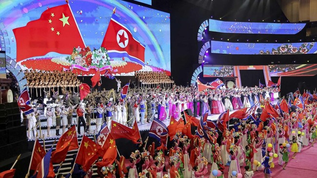 The flags of North Korea and China are waved on stage during a performance at the Pyongyang Indoor Stadium, during Chinese President Xi Jinping's state visit, in Pyongyang, North Korea, June 8, 2026, in this picture released by North Korea's official