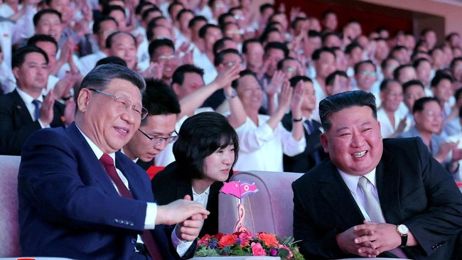 Chinese President Xi Jinping sits next to North Korean leader Kim Jong Un as he attends a performance at the Pyongyang Indoor Stadium, during his state visit, in Pyongyang, North Korea, June 8, 2026, in this picture released by North Korea's official