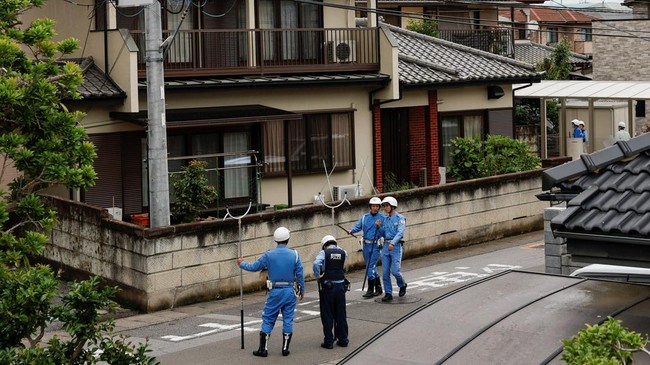Police officers with sticks search for a black bear that was spotted at a residential area in Utsunomiya, Tochigi Prefecture, Japan, June 9, 2026. REUTERS/Kim Kyung-Hoon