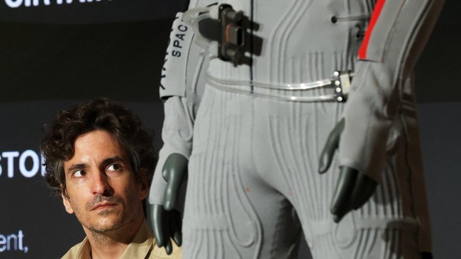 Lorenzo Bertelli looks up at the inner-layer liquid cooling and ventilation garment designed by Prada and Axiom Space during a press event in New York City, U.S., June 7, 2026. REUTERS/Heather Khalifa