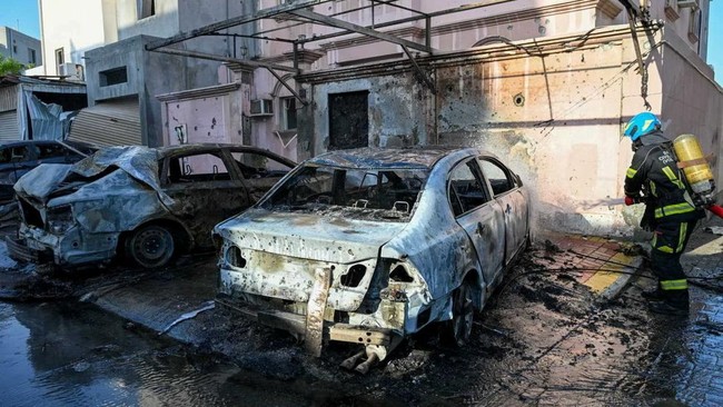 A firefighter works in the aftermath of Iranian drone attacks, according to Bahrain's Interior Ministry, at a location given as Bahrain, in this handout image released on June 11, 2026. Ministry of Interior of the Kingdom of Bahrain/Handout via REUTE
