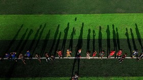 A drone view shows children taking part in a football training session led by coach Betinho at a community project "Projeto Elite Futebol e Inovacao Social", offering an alternative for young people in Complexo do Alemao favelas, an area affected by
