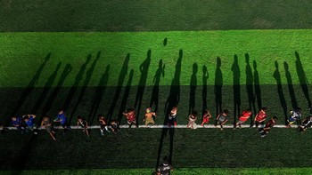 A drone view shows children taking part in a football training session led by coach Betinho at a community project "Projeto Elite Futebol e Inovacao Social", offering an alternative for young people in Complexo do Alemao favelas, an area affected by