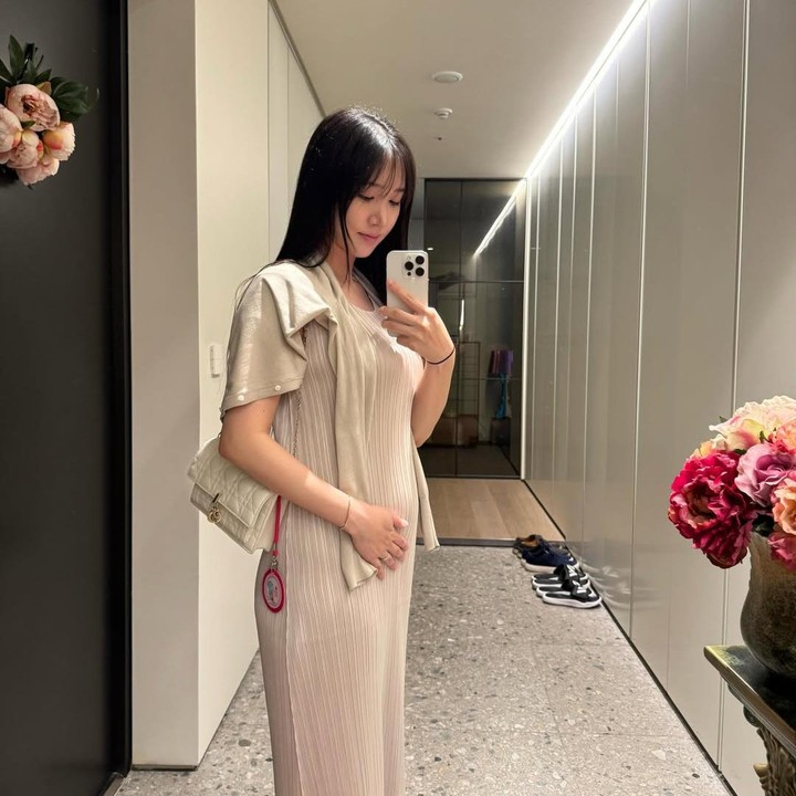 <p>Kini Yoo Kyung tampak begitu menikmati kehamilan pertamanya. Ia bahkan terlihat stylish dan makin cantik. Seperti dalam foto ini, Yoo Kyung mengenakan set dress terusan beige yang dipadu cape simple sambil memperlihatkan baby bump, manis dan modest ya Bunda. Foto: Instagram @Yukyung_922</p>