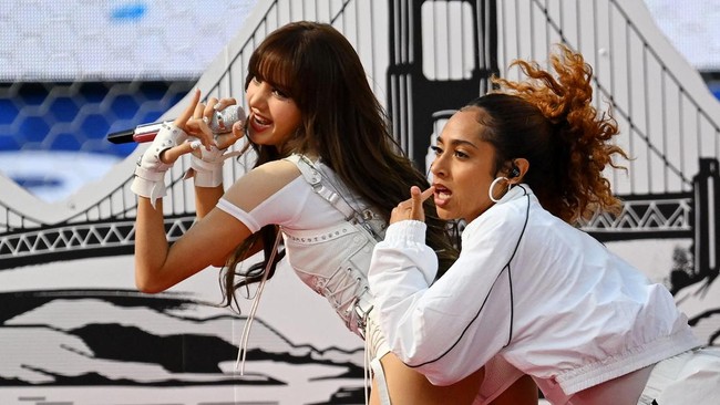 Thai rapper Lisa (L) performs during the opening ceremony of the 2026 World Cup football tournament ahead of the Group D football match between USA and Paraguay at the Los Angeles Stadium in Inglewood on June 12, 2026. (Photo by Patrick T. Fallon / A