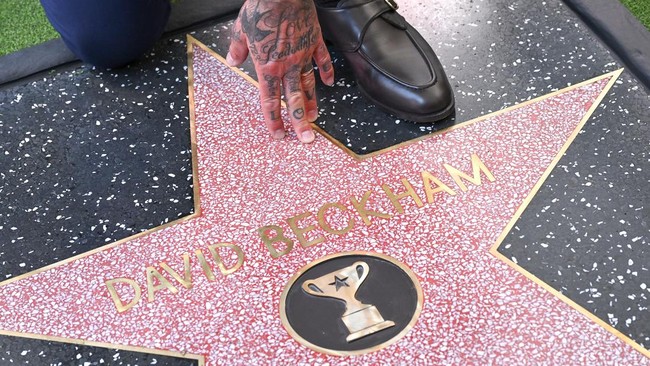 English former footballer David Beckham poses at his newly unveiled Hollywood Walk of Fame star during a ceremony in Hollywood, California, on June 12, 2026. (Photo by LISA O'CONNOR / AFP)