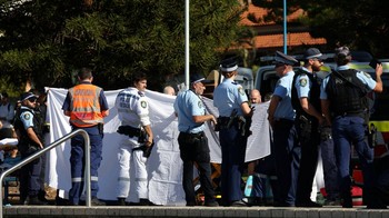 Police and emergency personnel at the scene after reports of a shark attack at Coogee Beach in Sydney, Australia, June 13, 2026. REUTERS/Hollie Adams