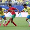 (L-R) Brazil's forward #11 Raphinha, Morocco's midfielder #06 Ayyoub Bouaddi, and Brazil's midfielder #20 Lucas Paqueta fight for the ball during the 2026 World Cup Group C football match between Brazil and Morocco at the New York/New Jersey Stadium