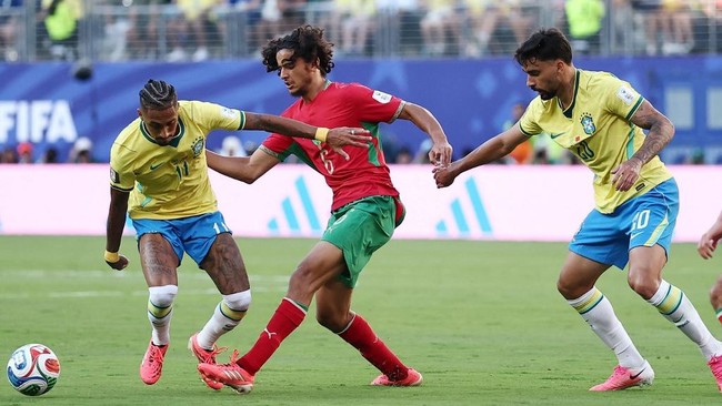 (L-R) Brazil's forward #11 Raphinha, Morocco's midfielder #06 Ayyoub Bouaddi, and Brazil's midfielder #20 Lucas Paqueta fight for the ball during the 2026 World Cup Group C football match between Brazil and Morocco at the New York/New Jersey Stadium 