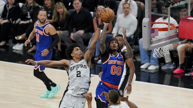 Jun 13, 2026; San Antonio, Texas, USA; New York Knicks guard Jordan Clarkson (00) makes a jump shot over San Antonio Spurs guard Dylan Harper (2) during the third quarter during game five of the 2026 NBA Finals at Frost Bank Center. Mandatory Credit: