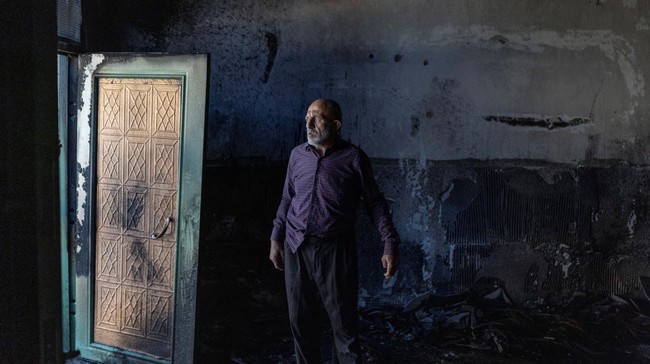 A Palestinian man inspects the damage inside a mosque reportedly burnt by Israeli settlers over night, in the Israeli occupied West Bank village of Jiljlia, just north of the West Bank city of Ramallah on June 17, 2026. Expanding Israeli settlements