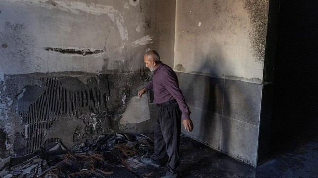 A Palestinian man inspects the damage inside a mosque reportedly burnt by Israeli settlers over night, in the Israeli occupied West Bank village of Jiljlia, just north of the West Bank city of Ramallah on June 17, 2026. Expanding Israeli settlements