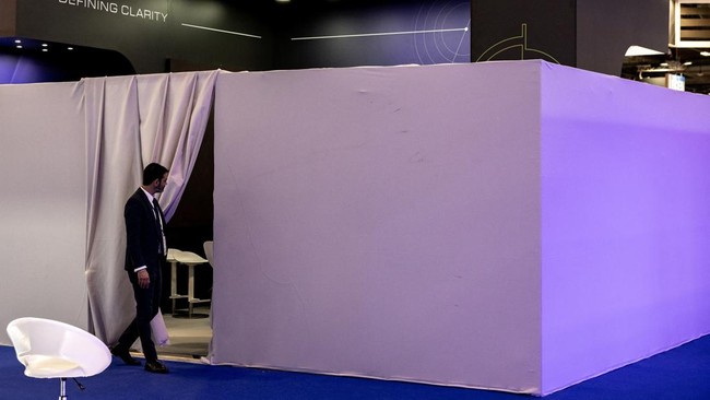 A security staff enters the closed stand of Israeli developer and manufacturer of defence and surveillance Electro-optic infrared (EO/IR) systems Controp at the Eurosatory land and airland defence and security trade fair, at the Paris-Nord Villepinte