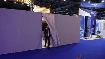 A man leaves the walled off booth of the Israeli company Marom Dolphin at the Eurosatory international land and air defence and security trade fair in Villepinte near Paris, France, June 15, 2026. REUTERS/Alice Sacco