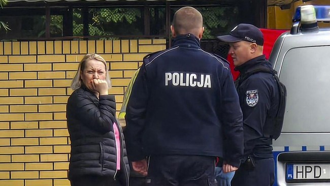 Police work at a crime scene covered with a tent (back R) in Biala Podlaska, eastern Poland  on June 16, 2026, where Russian artist Semyon Skrepetsky, known for his satirising Russian President Putin has been shot dead.