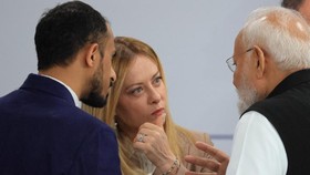 Italy's Prime Minister Giorgia Meloni (C) speaks with India's Prime Minister Narendra Modi ahead of a morning work meeting to revive balanced, inclusive, and sustainable economic growth for the benefit of all in the presence of the G7 countries, part