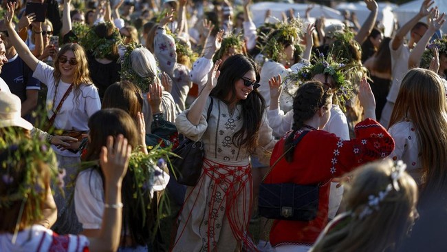 People wearing traditional garments prepare to dance during the Ivana Kupala holiday celebration, an ancient tradition with roots in pagan times, amid Russia's attack on Ukraine, at the National Museum of Folk Architecture and Life of Ukraine, in Kyi