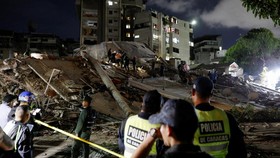 Police officers and rescuers work at the site of damaged buildings in the aftermath of an earthquake, in Caracas, Venezuela, June 24, 2026. REUTERS/Fausto Torrealba
