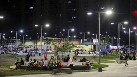 People rest in a square out of fear of going back into buildings, as emergency services (not pictured) work at the site of a collapsed building after earthquakes hit the country, in Caracas, Venezuela, June 25, 2026. REUTERS/Leonardo Fernandez Vilori