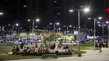 People rest in a square out of fear of going back into buildings, as emergency services (not pictured) work at the site of a collapsed building after earthquakes hit the country, in Caracas, Venezuela, June 25, 2026. REUTERS/Leonardo Fernandez Vilori