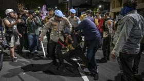 Indonesian police arrest a student following clashes during protest against a rise in non-subsidised fuel prices, inefficient government spending and military involvement in civilian affairs and the government's free school meals programme (MBG) in S