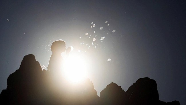 A girl blows soap bubbles while celebrating the summer solstice at the Kokino Megalithic Observatory, near Kumanovo, North Macedonia, June 21, 2026. REUTERS/Ognen Teofilovski
