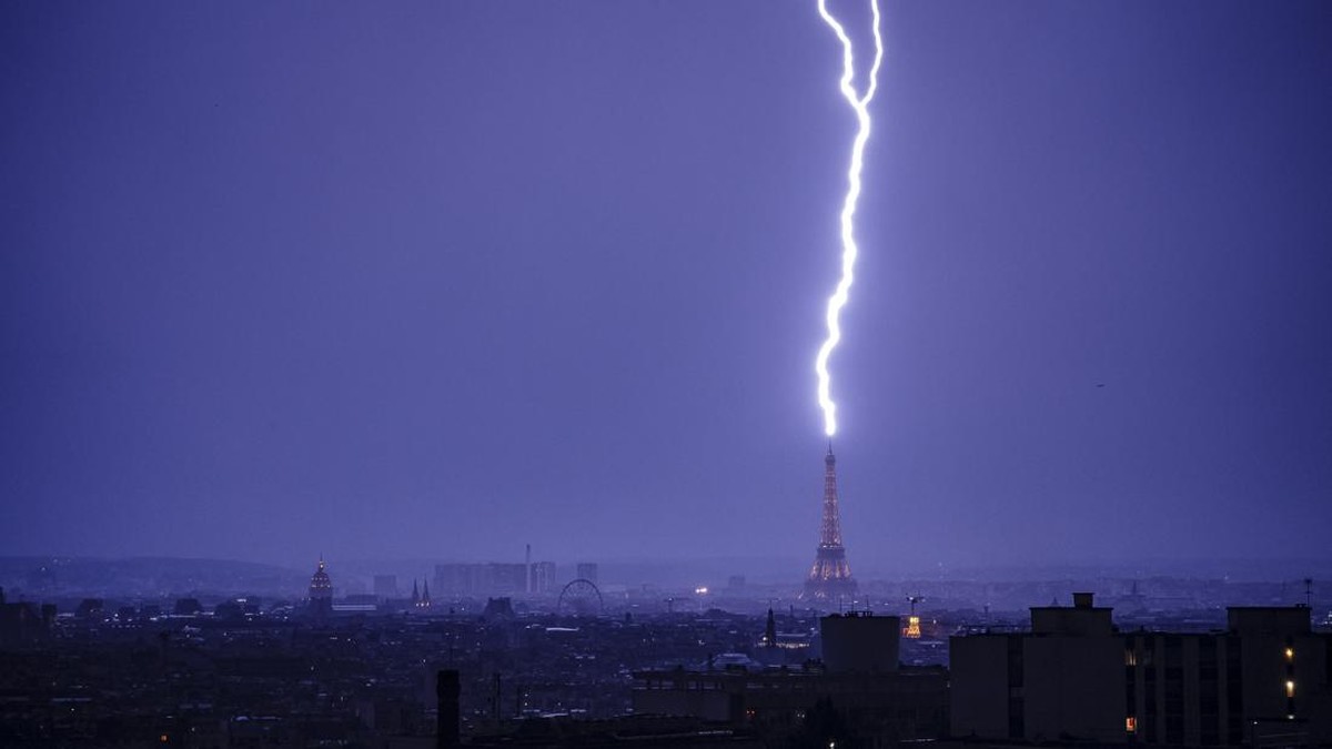 Lightning strikes the Eiffel Tower during a thunderstorm in Paris on June 27, 2026. (Photo by DIMITAR DILKOFF / AFP)