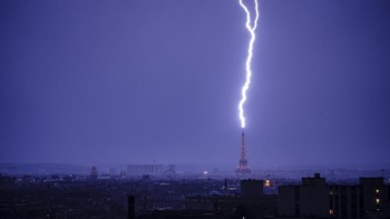 Lightning strikes the Eiffel Tower during a thunderstorm in Paris on June 27, 2026. (Photo by DIMITAR DILKOFF / AFP)