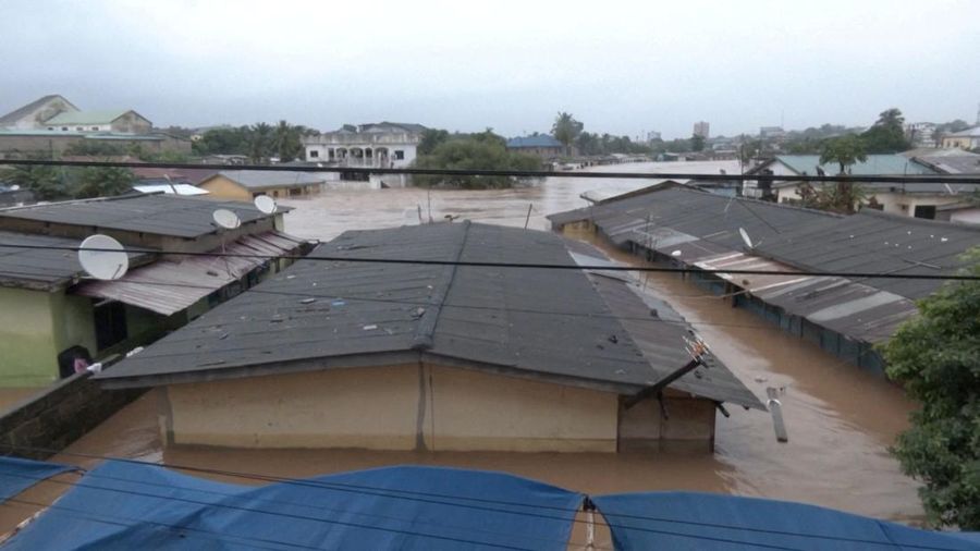 A person wades through floodwaters, in Accra, Ghana, in this still image taken from a video, June 29, 2026. Reuters TV via REUTERS