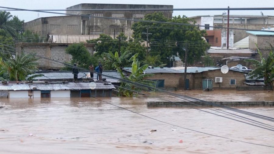 A person wades through floodwaters, in Accra, Ghana, in this still image taken from a video, June 29, 2026. Reuters TV via REUTERS