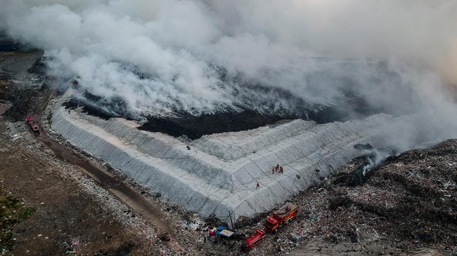 Foto udara petugas pemadam kebakaran berusaha memadamkan api di Tempat Pembuangan Akhir (TPA) Jatiwaringin, Kabupaten Tangerang, Banten, Selasa (30/6/2026). BPBD Kabupaten Tangerang mengerahkan sembilan unit mobil dan 45 personel untuk memadamkan keb