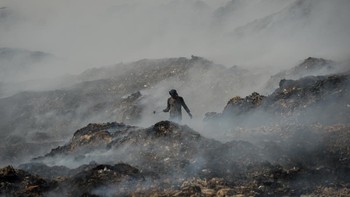 Pemulung memilah sampah pada tumpukan sampah yang terbakar di Tempat Pembuangan Akhir (TPA) Jatiwaringin, Kabupaten Tangerang, Banten, Rabu (1/7/2026). Badan Nasional Penanggulangan Bencana (BNPB) menyatakan area yang terdampak kebakaran TPA Jatiwari