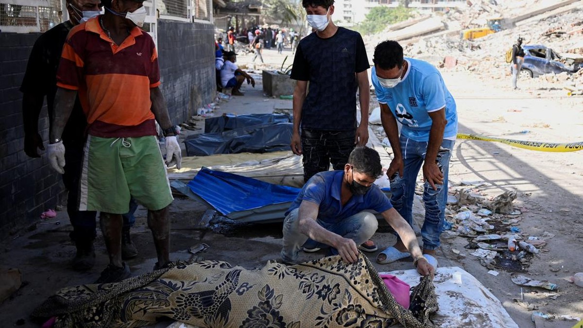 A man identifies the body of a relative, as rescue operations continue, after earthquakes hit the country, in La Guaira, Venezuela, June 27, 2026. REUTERS/Maxwell Briceno