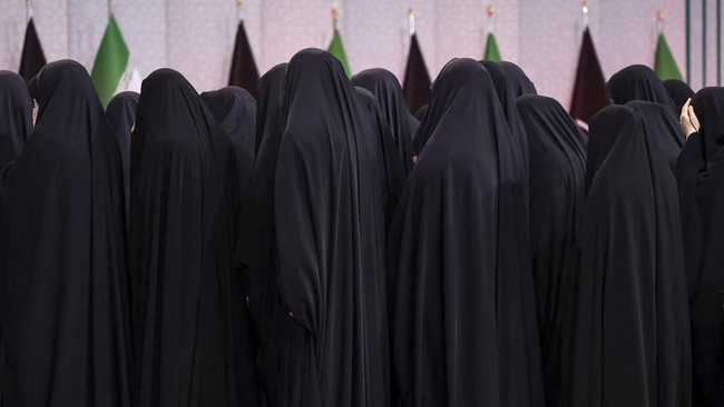Women gather near the coffins of Iran's late Supreme Leader Ayatollah Ali Khamenei and his family members, as international delegates participate in a farewell ceremony for Khamenei, who was killed on February 28 during Israeli and U.S. airstrikes on