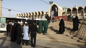 People walk on the day international delegates participate in a farewell ceremony for Iran's late Supreme Leader Ayatollah Ali Khamenei,