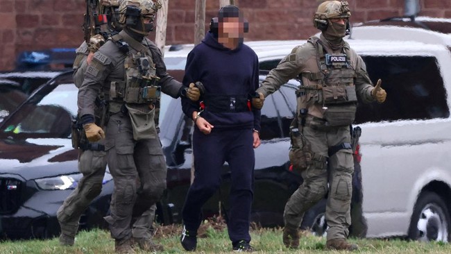 FILE PHOTO: Police escort Serhii K. to a helicopter following a hearing with the German Federal Public Prosecutor, after Italy's top court approved the handover to Germany of the Ukrainian man, suspected of coordinating the 2022 sabotage of the Nord 