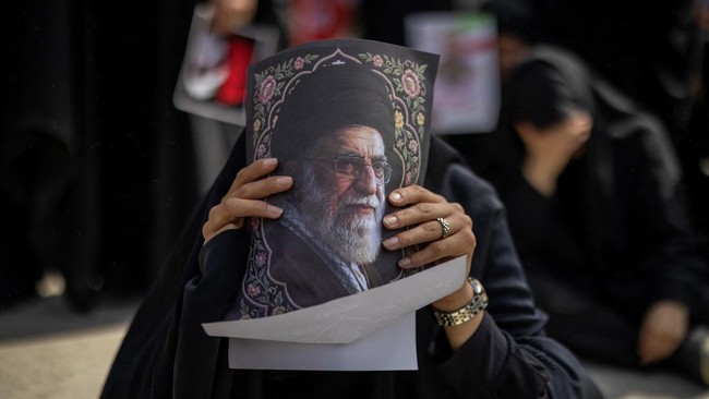 A mourner reacts during a public farewell ceremony while holding a portrait of late Supreme Leader Ayatollah Ali Khamenei, who was killed on February 28 in Israeli and U.S. airstrikes, at the Imam Khomeini Grand Mosalla, in Tehran, Iran July 4, 2026.