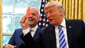 FILE PHOTO: U.S. President Donald Trump holds up a red card as he meets with FIFA President Gianni Infantino in the Oval Office of the White House in Washington, U.S., August 28, 2018. REUTERS/Leah Millis/File Photo