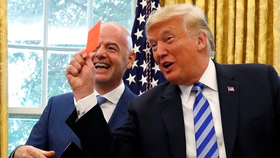 FILE PHOTO: U.S. President Donald Trump holds up a red card as he meets with FIFA President Gianni Infantino in the Oval Office of the White House in Washington, U.S., August 28, 2018. REUTERS/Leah Millis/File Photo