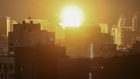 An explosion lights up the sky over the city during a Russian missile and drone strike, amid Russia's attack on Ukraine, in Kyiv, Ukraine July 6, 2026. REUTERS/Gleb Garanich