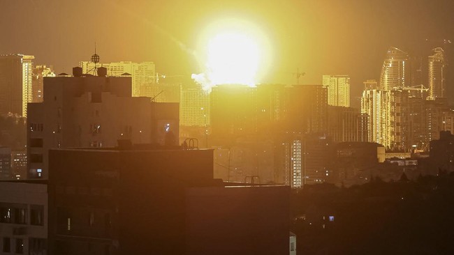 An explosion lights up the sky over the city during a Russian missile and drone strike, amid Russia's attack on Ukraine, in Kyiv, Ukraine July 6, 2026. REUTERS/Gleb Garanich