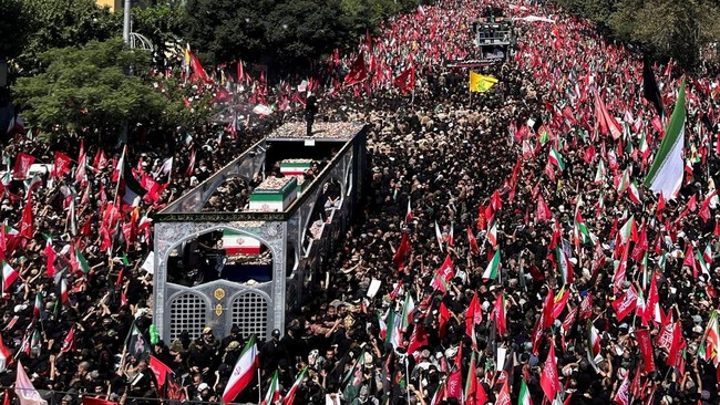 A vehicle carrying coffins of Iran's late Supreme Leader Ayatollah Ali Khamenei and his family members, makes its way as people attend a funeral procession for Khamenei, who was killed on February 28 in Israeli and U.S. airstrikes, in Tehran, Iran, J