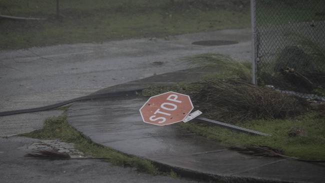 A traffic sign lies on the ground after being knocked down by strong winds brought by Super Typhoon Bavi in Guam on July 6, 2026. (Photo by Yuichi YAMAZAKI / AFP)