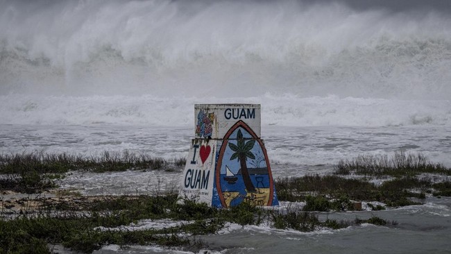 High waves crash against the coastline at a beach as the forecasted Super Typhoon Bavi approaches in Guam on July 5, 2026. People in Guam and the Northern Marianas moved to emergency evacuation centers and made last-minute preparations on July 5, hou