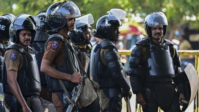 Police personnel stand guard outside the Negombo prison on the outskirts of Colombo on July 7, 2026, following clashes between inmates of two drug gangs. Clashes in a Sri Lankan jail have killed 23 people, including four guards, and wounded more than