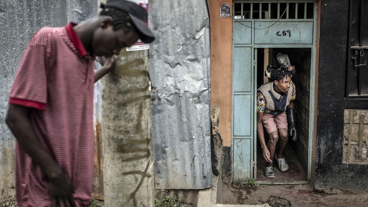 Rodgers Oloo Magutha, 28, popularly known as Nairobi Birdman, carries some of the wild birds under his care on his shoulders and head as he leaves his apartment to buy meat to feed them in Kayole, a low-income neighbourhood on the outskirts of Nairob