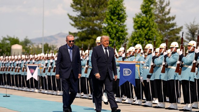 U.S. President Donald Trump walks with Turkish President Recep Tayyip Erdogan during a formal arrival at the Bestepe Presidential Compound at the NATO summit in Ankara, Turkey, Tuesday, July 7, 2026.     Emrah Gurel/Pool via REUTERS